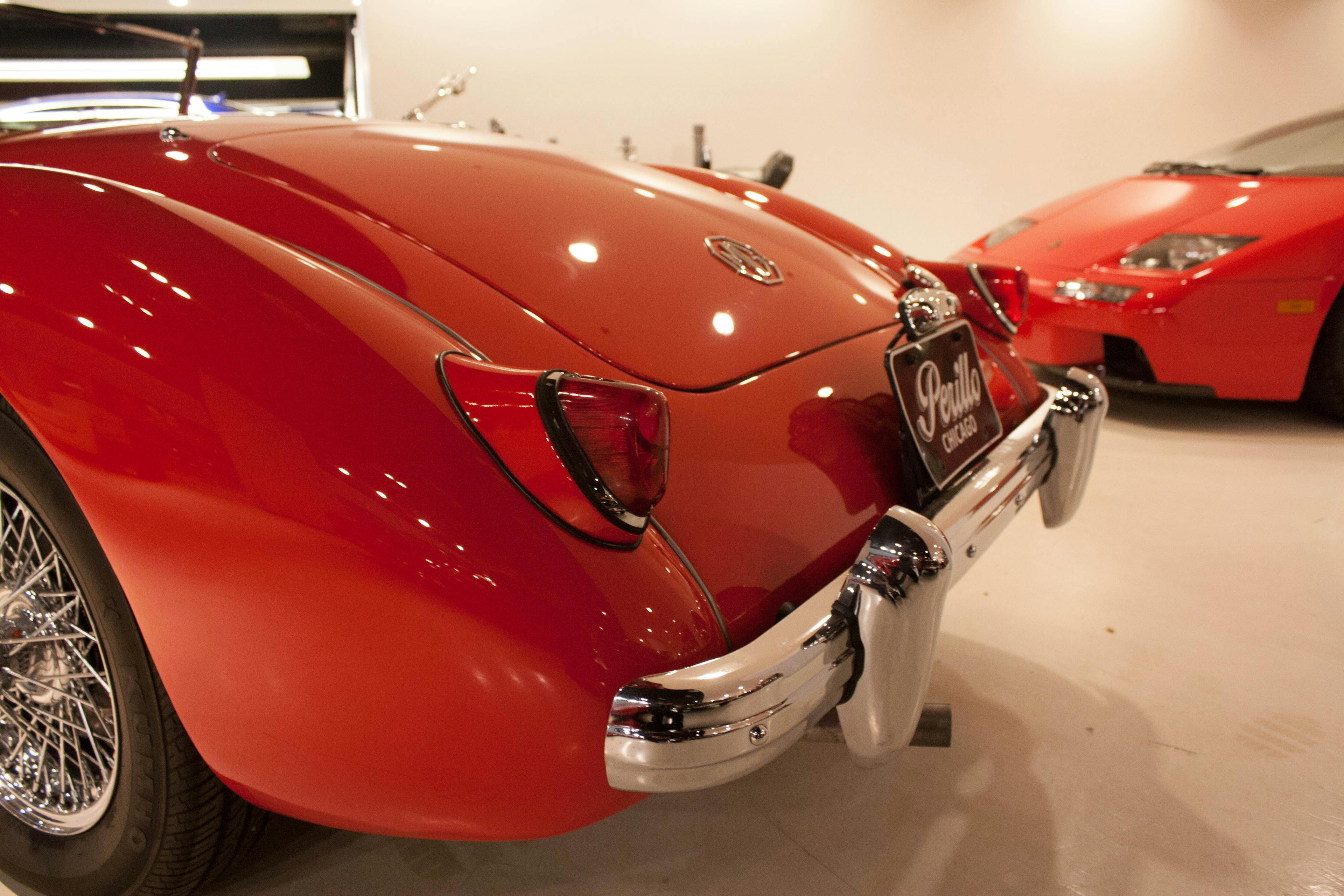 Three-quarter rear view of a mid-20th-century MG MGA automobile at the Perillo dealership in Chicago.